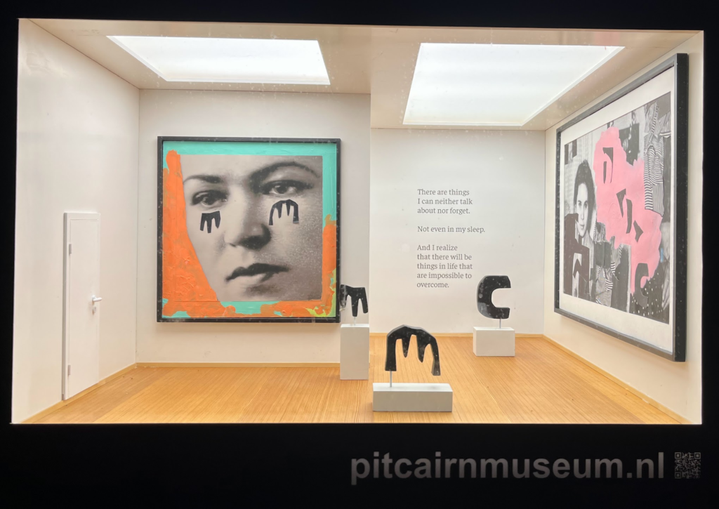A photograph of a large shoebox-sized L-shaped gallery space. From left to right, a white door, a collage piece of a person with black paper cutout tears on their face on a blue and orange background, in a black frame. Then, three black sculptures on white pedestals, the first two in the shape of the tears from the first piece, then the third approximately C-shaped. Behind these sculptures is a poem -- "There are things / I can neither talk /about nor forget. Not even in my sleep. And I realize / that there will be / things in life that / are impossible to / overcome." -- and then on the right wall there is another collage piece, of a person looking at the camera and then a blob of pink paint, all surrounded by cutouts of various unspecific black shapes and various fabrics. It's in a black frame.