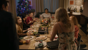 Screencap. Captain Daughter and Leary stand in front of a dinner table with on it, a gold-coloured tablecloth, on which are about a dozen plates and glasses, and three gourmetstellen -- one of which is the kind with little pans, one of which is behind a flower arrangement that really shouldn't be between two heat sources, and one of which is the pan-less kind, though it's also weirdly sat on the corner of the table to Captain Daughter can put her hands on it and hurt herself. It doesn't look like the food is actively being cooked or anything, but it's fine.